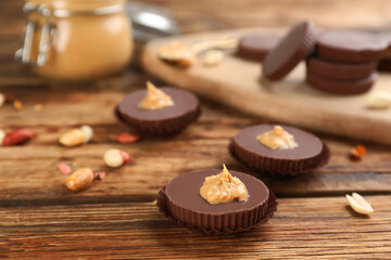 Delicious peanut butter cups on wooden table