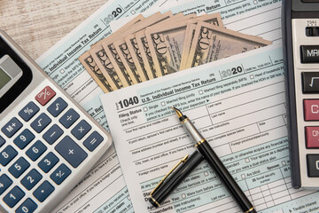 1040 individual form, with us money.  Tax time concept