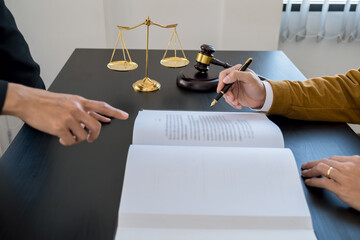  Judge gavel with Justice lawyers having team meeting at law firm background. Concepts of Law and...