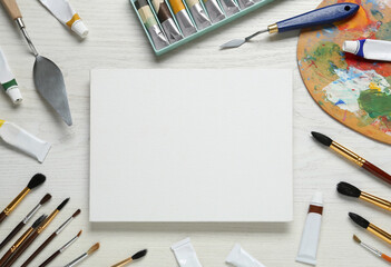 Blank canvas, tools, palette and paints on white wooden table, flat lay. Space for text - Powered by Adobe