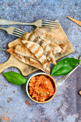  Grilled chicken fillets with  olive oil, chili pepper,   and tomato paste 