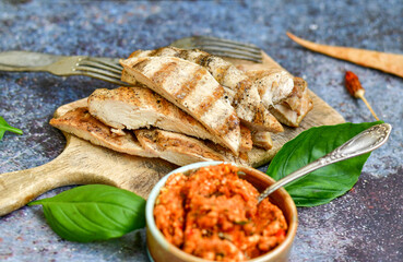  Grilled chicken fillets with  olive oil, chili pepper,   and tomato paste 