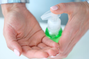 Woman applies antiviral bacteria antiseptic to hands