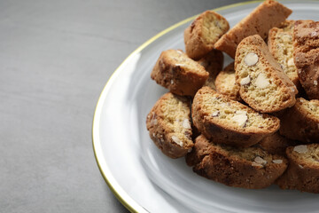 Traditional Italian almond biscuits (Cantucci) on grey table, closeup