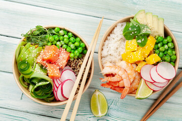 Poke bowls with shrimps, salmon, avocado and mango