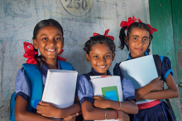 Indian Rural School Girls Kids Holding Books Standing in School - obrazy, fototapety, plakaty