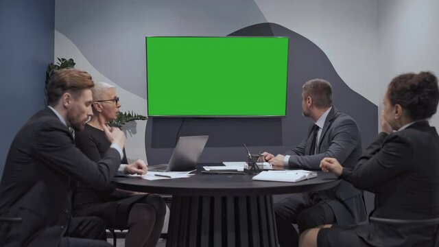 Corporate team shocked by bad statistics data on green screen company bankruptcy