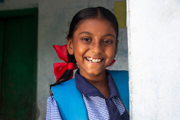portrait of a rural school girl smiling and standing in school