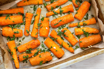 Homemade Roasted Carrots with Herbs, top view. Flat lay, overhead, from above.