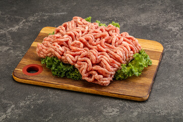 Raw pork minced meat over board