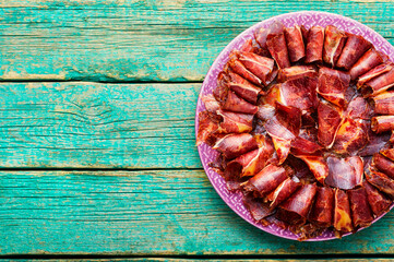 Spicy beef jerky on wooden background,copy space