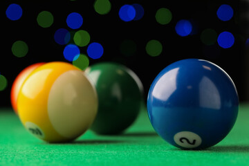 Many colorful billiard balls on green table, closeup