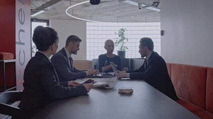 Company workers reporting to female team leader at business meeting in office