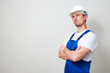 Portrait of young handyman standing on white background