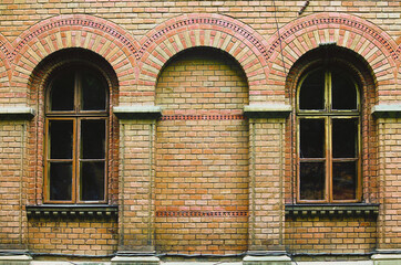 Close-up view of ancient brick wall with windows. Abstract background. Residence of Bukovinian and Dalmatian Metropolitans (Chernivtsi National University).UNESCO World Heritage Site. Chernivtsi