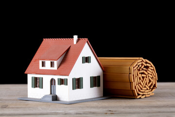 A roll of bamboo slips and a house model on the table