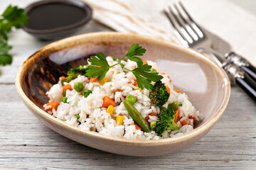 Bowl with tasty rice and vegetables