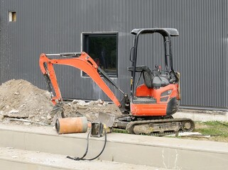 Mini excavator with construction equipment at work for replacement  the cables or pipelines...
