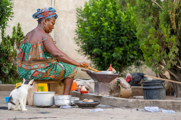 image of african woman cooking out door-food concept