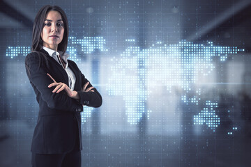 Pretty european businesswoman with global map interface hologram standing in blurry office interior. Technology and network concept. Double exposure.