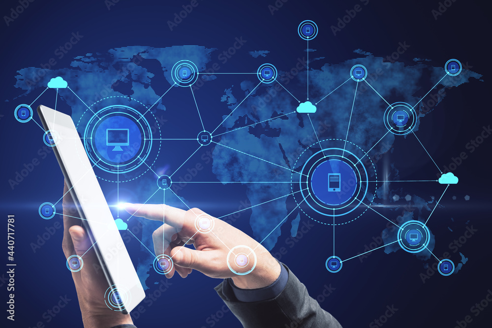 Poster Hand using tablet with abstract computer map and digital icons hologram on blue background. Cloud computing and data storage concept.