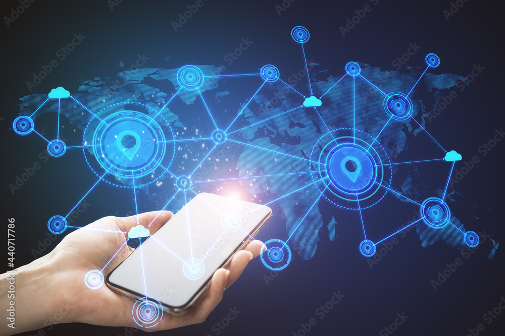 Poster Hand using mobile phone with abstract map and location pins hologram on blue background. Geolocation and globalization concept.