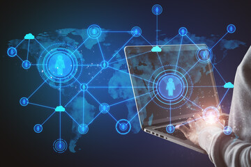 Close up of hands using laptop with abstract social network hologram on blue background. Recruiting and cloud technology concept.