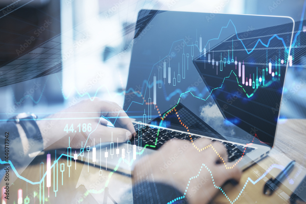 Poster close up of hands using laptop with forex chart on blurry desktop background. finance and fintech co
