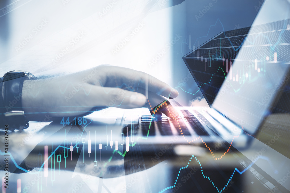 Poster close up of hands using laptop with forex chart on blurry desktop background. finance and trend conc