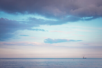 Sunset dramatic sky clouds over sea waves