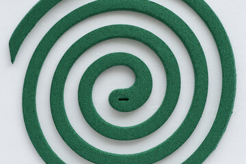 Green mosquito coil on white background.