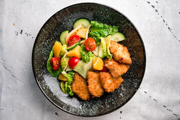 Colorful vegetable dish with mixed orange, nuggets, lettuce and tomatoes. Beautiful view of restaurant healthy food