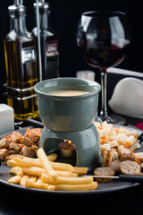 Traditional set of utensils for fondue, with bread, cheese