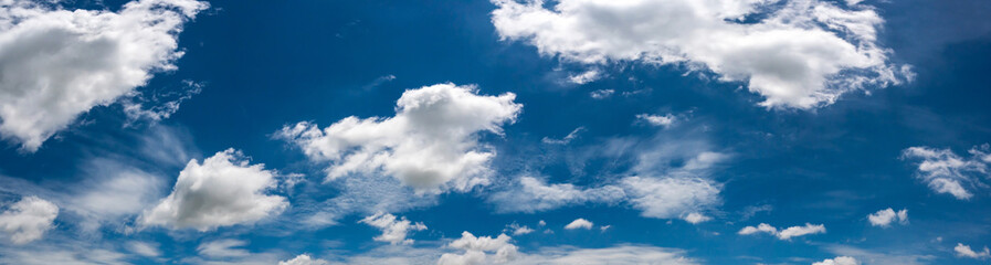 Panorama Sunlight with blue sky on dark background.Vivid sky on white clouds.