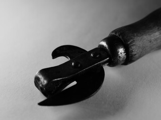 Closeup shot of an aged bottle opener on a white surface