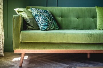 Green sofa in elegant apartment. Home staging