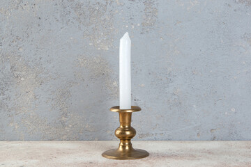 Antique candlestick on concrete background