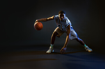 Basketball player with ball, practicing in action - Powered by Adobe