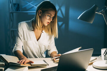 Pandemic lockdown education. Distant learning. Student reading books doing homework preparing to exams sitting at desk
