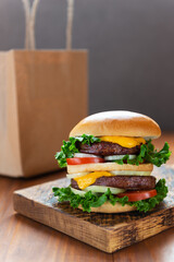 Vegan burger on a wooden board. Food delivery concept.