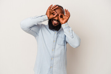 African american man with beard isolated on pink background showing okay sign over eyes