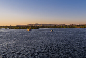 Panoramic view of traditional boats on the Nile River near Luxor, Egypt at sunset