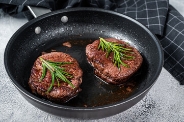 Grilled Fillet Mignon tenderloin meat beef steaks in pan. White background. Top view
