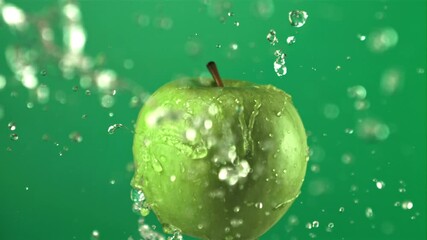 Super slow motion green apple with water droplets. On a green screen. Filmed on a high-speed camera at 1000 fps.High quality FullHD footage - Powered by Adobe