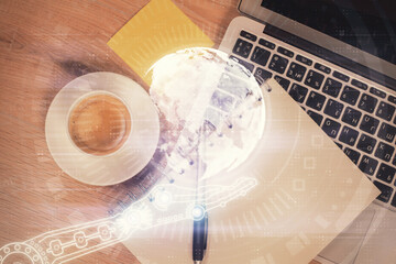 Double exposure of map hologram drawing over study table background with computer. Concept of international network. Top view.