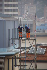 Workers on the roof of a building