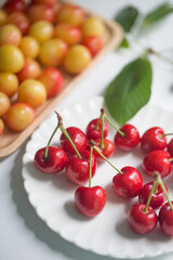 Fresh cherries with cherry leaf isolated on a white background.