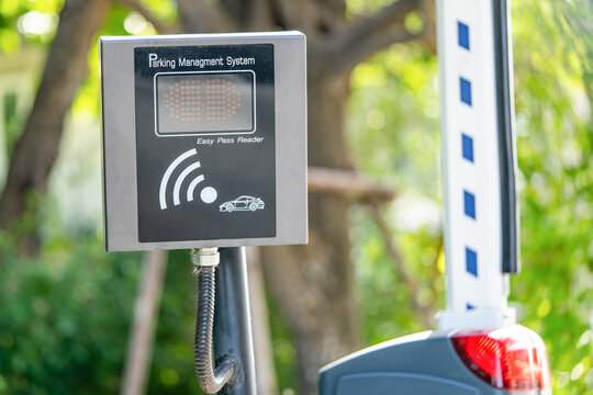 Easy pass bluetooth long range remote reader for access control express car way gate in front of modern office building, security parking management technology system..