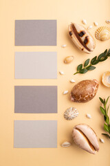 Composition of gray paper business cards, seashells, green boxwood. mockup on orange background. top view, copy space.