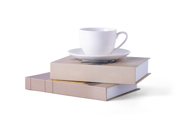 coffee mug or cup with handle on the books. isolate on white background with clipping path.